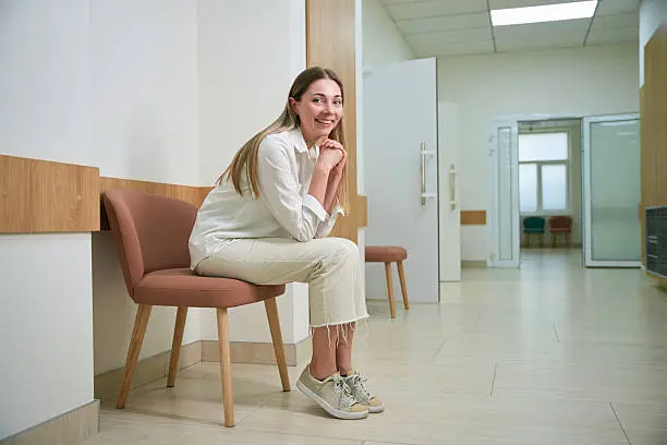 A relaxed patient sitting calmly in a bright, welcoming waiting area